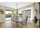 Bright dining area with large windows, elegant lighting, and scenic backyard views at 93 E Santa Lucia Ln, Queen Creek, AZ 85140