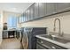 Functional laundry room with sink, counter space, and overhead cabinets at 93 E Santa Lucia Ln, Queen Creek, AZ 85140