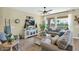 Bright living room with ceiling fan, modern furniture, and view to outdoors at 93 E Santa Lucia Ln, Queen Creek, AZ 85140