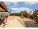 Back patio features brick planters, colorful flowers, and tile flooring, perfect for outdoor enjoyment at 9622 N 112Th Ave, Sun City, AZ 85351