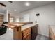 Indoor bar area with beautiful wood finishes and a granite countertop at 9622 N 112Th Ave, Sun City, AZ 85351