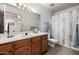 Bathroom featuring a sink vanity with natural wood finish and updated fixtures at 9622 N 112Th Ave, Sun City, AZ 85351