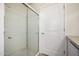 Modern bathroom with glass-enclosed shower, complemented by a white door at 9622 N 112Th Ave, Sun City, AZ 85351