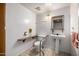 Bathroom featuring a pedestal sink, grab bars, accessible toilet and medicine cabinet at 9622 N 112Th Ave, Sun City, AZ 85351