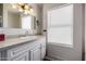 Bathroom featuring a single vanity, window, and ample counter space at 9622 N 112Th Ave, Sun City, AZ 85351