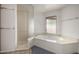 Bathroom features a jacuzzi tub, glass enclosed shower and frosted window at 9622 N 112Th Ave, Sun City, AZ 85351