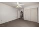 Bright bedroom with carpet, ceiling fan, neutral paint, and sliding door closet at 9622 N 112Th Ave, Sun City, AZ 85351