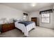 Neutral bedroom with a comfortable bed, dresser, and natural light from two windows at 9622 N 112Th Ave, Sun City, AZ 85351