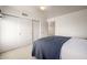 Simple bedroom with a bed, closet, and a door leading to another room at 9622 N 112Th Ave, Sun City, AZ 85351
