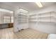 Versatile bonus room with built-in shelving, a desk, and lots of storage space at 9622 N 112Th Ave, Sun City, AZ 85351