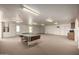 Large bonus room with a pool table and plenty of lighting at 9622 N 112Th Ave, Sun City, AZ 85351