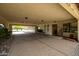 Long covered driveway/carport leading to a beautifully carved front door and landscaped yard at 9622 N 112Th Ave, Sun City, AZ 85351