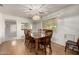 Formal dining room features hardwood floors and a charming chandelier with seating for six at 9622 N 112Th Ave, Sun City, AZ 85351