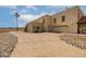 Home featuring three-car garage and desert landscaping with a palm tree at 9622 N 112Th Ave, Sun City, AZ 85351