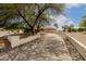 Long driveway lined with desert landscaping leading to a beige stucco home at 9622 N 112Th Ave, Sun City, AZ 85351