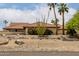 Tan house with desert landscaping, red tile roof and palm trees at 9622 N 112Th Ave, Sun City, AZ 85351