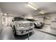 Spacious garage featuring a Ford F-150, Ford Explorer, and a sliding door at 9622 N 112Th Ave, Sun City, AZ 85351