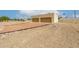 Two-car garage with brown doors and desert landscaping, with gravel and boulders at 9622 N 112Th Ave, Sun City, AZ 85351
