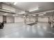 Vast garage with a car lift access, shelving, and storage space at 9622 N 112Th Ave, Sun City, AZ 85351