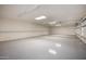 Bright and spacious three car garage with epoxy flooring and built-in shelving at 9622 N 112Th Ave, Sun City, AZ 85351