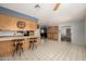 Open concept kitchen with a breakfast bar and an adjoining living area, perfect for entertaining at 9622 N 112Th Ave, Sun City, AZ 85351