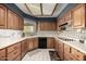 Spacious kitchen featuring wood cabinets, modern appliances, and tile floors at 9622 N 112Th Ave, Sun City, AZ 85351