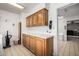 Well-lit laundry area with ample cabinet space and a view into the home at 9622 N 112Th Ave, Sun City, AZ 85351