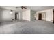 Large living room featuring gray carpeting, blue walls, and a ceiling fan at 9622 N 112Th Ave, Sun City, AZ 85351