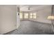 Large living room with bay window, ceiling fan, and carpet at 9622 N 112Th Ave, Sun City, AZ 85351