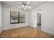 Cozy living room with hardwood floors, a ceiling fan, and lots of natural light at 9622 N 112Th Ave, Sun City, AZ 85351