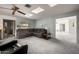 Large living room featuring gray carpeting, skylights and sectional sofa at 9622 N 112Th Ave, Sun City, AZ 85351