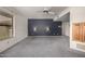 Living room with carpeting, blue accent wall, sconce lighting and window at 9622 N 112Th Ave, Sun City, AZ 85351