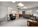 Living room with skylights, wet bar, gray carpeting and comfortable seating at 9622 N 112Th Ave, Sun City, AZ 85351