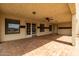 Spacious covered patio with tile flooring, a ceiling fan, and sliding glass doors at 9622 N 112Th Ave, Sun City, AZ 85351