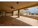 Large, covered patio with tile flooring, ceiling fans, and access to the garage at 9622 N 112Th Ave, Sun City, AZ 85351