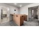 Wet bar with wood counter and gray carpeting at 9622 N 112Th Ave, Sun City, AZ 85351