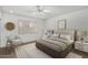 Charming bedroom with a plush bed, stylish decor, and natural light streaming through the window at 9805 W Gulf Hills Dr, Sun City, AZ 85351