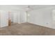 Bright bedroom features neutral carpet, a ceiling fan, and natural light from the window at 9805 W Gulf Hills Dr, Sun City, AZ 85351