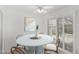 Bright dining area featuring a round table, stylish chairs, and sliding doors to the patio at 9805 W Gulf Hills Dr, Sun City, AZ 85351