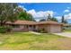 Charming single-story home featuring a brick facade, lush lawn, and well-manicured landscaping at 9805 W Gulf Hills Dr, Sun City, AZ 85351