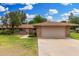 Charming single-story home featuring mature trees and an attached two-car garage at 9805 W Gulf Hills Dr, Sun City, AZ 85351