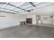 Well-lit garage featuring concrete flooring, shelving, and a workbench at 9805 W Gulf Hills Dr, Sun City, AZ 85351