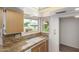 The kitchen showcases stone countertops, a stainless steel sink, and a view of the neighborhood at 9805 W Gulf Hills Dr, Sun City, AZ 85351