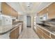 Galley kitchen with updated stone countertops, white appliances, and ample cabinet storage at 9805 W Gulf Hills Dr, Sun City, AZ 85351