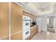 Bright kitchen with stone countertops, white appliances, a built-in oven and microwave, and plenty of storage at 9805 W Gulf Hills Dr, Sun City, AZ 85351