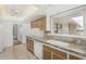 Bright kitchen featuring stone countertops, stainless steel sink, and large window at 9805 W Gulf Hills Dr, Sun City, AZ 85351