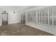 Bright living room features neutral carpet, sliding glass door and shuttered windows at 9805 W Gulf Hills Dr, Sun City, AZ 85351