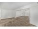Open-concept living room featuring carpet floors, neutral walls, and great natural light at 9805 W Gulf Hills Dr, Sun City, AZ 85351