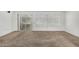 Bright living room area with neutral walls and carpet, offering versatile living space at 9805 W Gulf Hills Dr, Sun City, AZ 85351