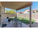 Covered patio with table and chairs overlooks a well-maintained yard at 17434 N 46Th Pl, Phoenix, AZ 85032